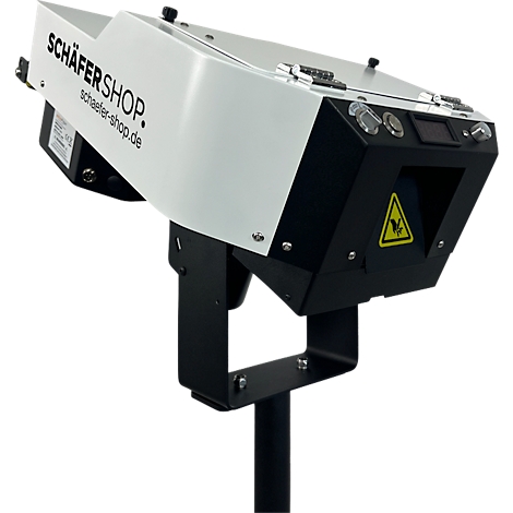Een grijs apparaat van Schäfer Shop, op een zwarte houder. Geel waarschuwingsbord.