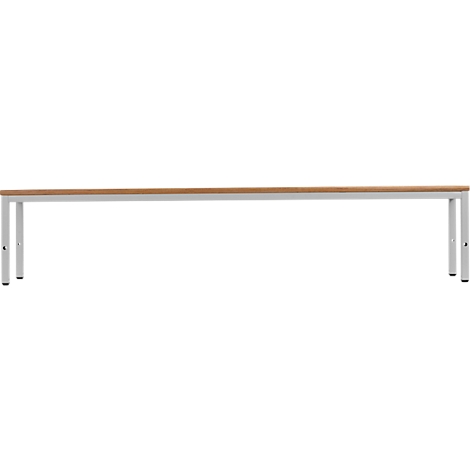 A long table with a light brown tabletop and silver metal legs. The table stands against a white background.