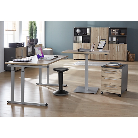 Office with height-adjustable desks, office chair, and mobile pedestal.