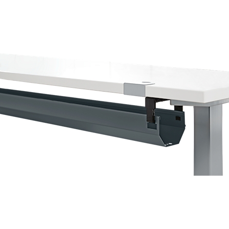 Dark gray cable tray under a white table top. Black bracket at the table edge.