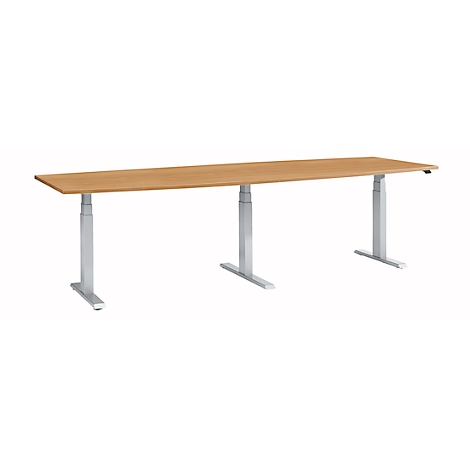A rectangular, height-adjustable desk with a light brown tabletop and silver legs. Ideal for office work.