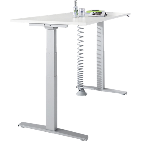 White, height-adjustable desk with gray legs, a water bottle and glass are on the table top.
