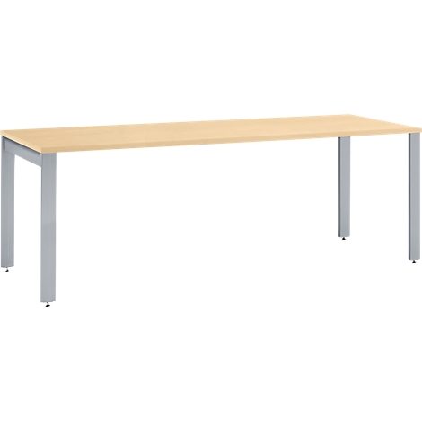 A rectangular light wood table with silver metal legs.