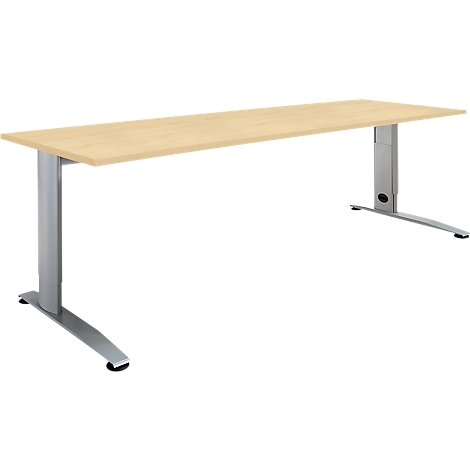 A light, rectangular desk with two silver, height-adjustable legs. The tabletop is light and wood-colored.