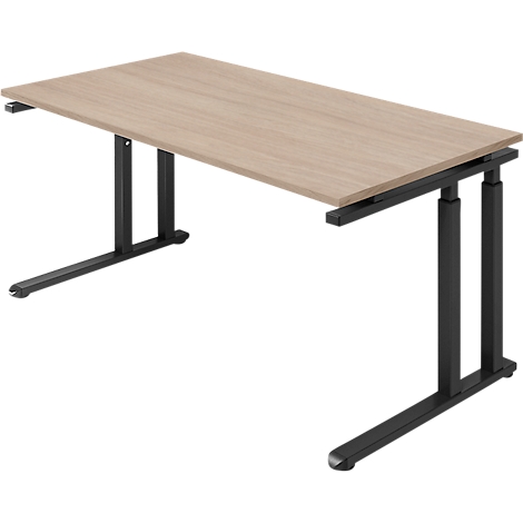 Beige desk top with black, adjustable height legs. Perspective view.