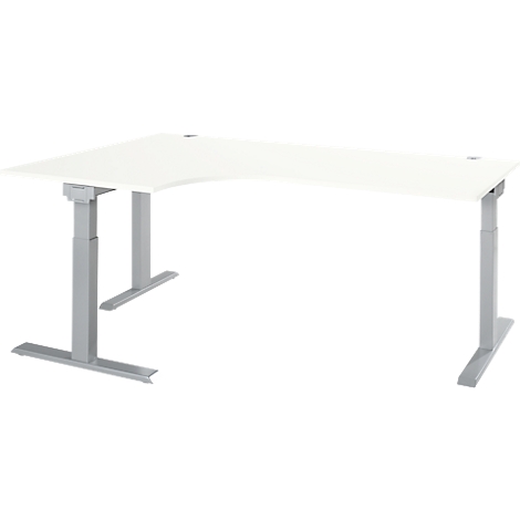 A white, angled desk with silver, height-adjustable legs. On a white background.