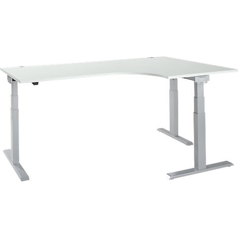 A white, L-shaped standing desk with silver, height-adjustable legs, set against a white background.