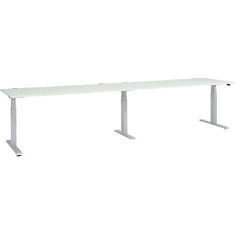 A long, white desk with height-adjustable, silver legs.