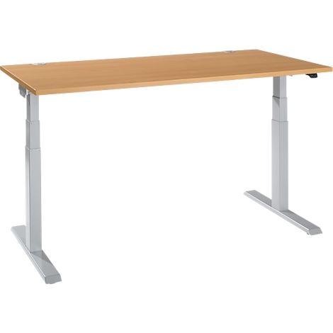 An adjustable-height desk with a light brown tabletop and silver legs.