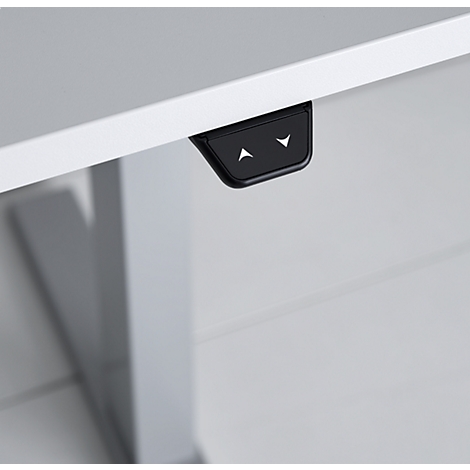 Black control panel with arrow buttons on a white desk edge. The arrows point up and down.