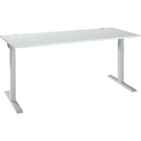 A white, height-adjustable desk against a light background. Silver legs, rectangular tabletop with holes.