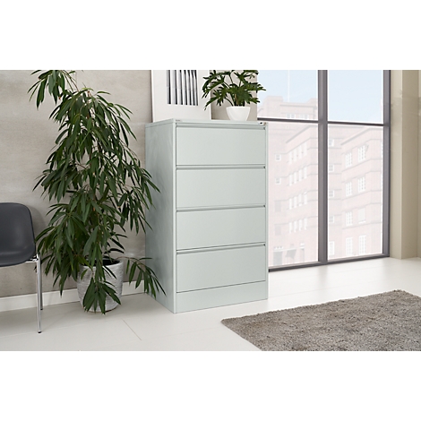 Light grey filing cabinet in an office with window and plant.