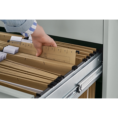 Hand in blue and white shirt reaching into a file cabinet with brown hanging files.