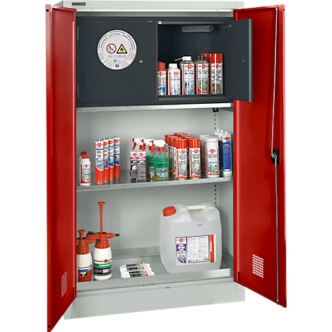 Roter, geöffneter Sicherheitsschrank mit verschiedenen Chemikalien. Aufkleber: Achtung, Gefahrensymbol. Aufteilung in mehrere Fächer.