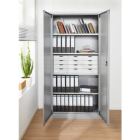 Open gray file cabinet with folders, drawers and books. On light wooden floor.