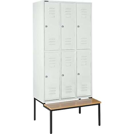 Witte locker met zes deuren, staat op een houten bankje met zwarte poten.