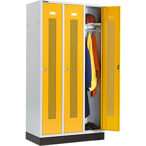 Yellow lockers with perforated pattern, one door open. Inside: helmet, jackets, shoes.