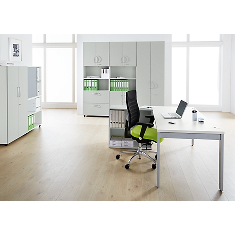 Bright office space with desk, chair, filing cabinets, and laptop. Lots of light through large windows.