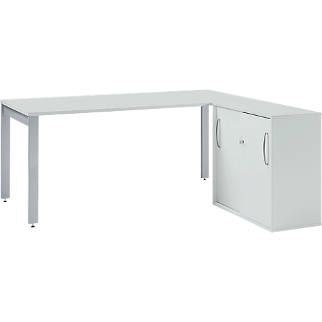 White corner desk with silver legs and cabinet. L-shaped tabletop, cabinet with handles.