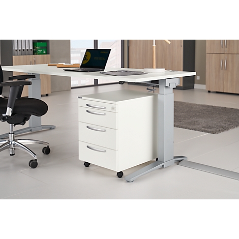 A height-adjustable, white desk with a drawer cabinet, laptop, chair and lamp.