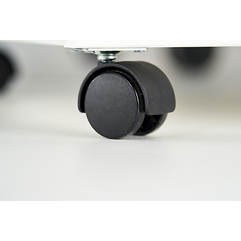 Close-up of a black caster wheel with a silver-colored fixing element on a white surface.