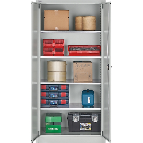 Open cabinet with various stored materials, including cardboard boxes, toolboxes, and plastic containers.