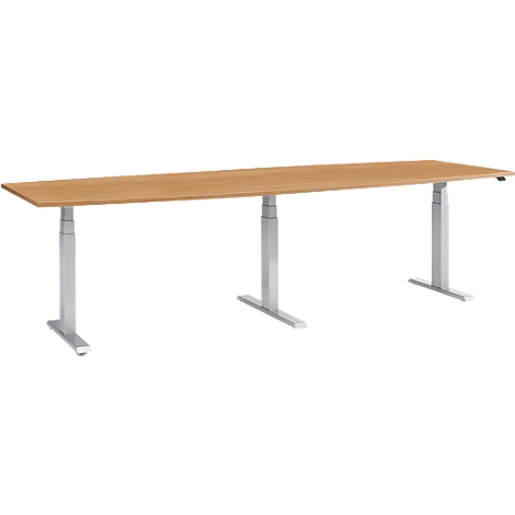 Long, rectangular, height-adjustable desk with a light wood look, gray legs and a gray base.