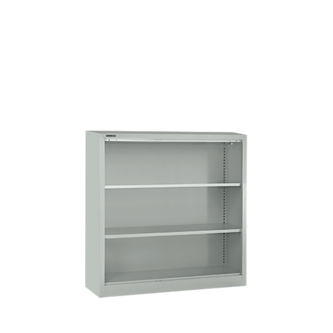 Gray bookshelf with three shelves, against a white background. Simple design, clean lines.