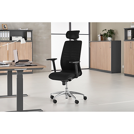 Black office chair with headrest, in front of a bright background. Desk, cabinet and window in the background.