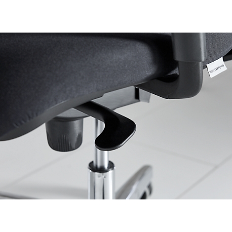 Close-up of a black office chair. Lever under the seat, struts and fabric. Label on the frame with lettering.