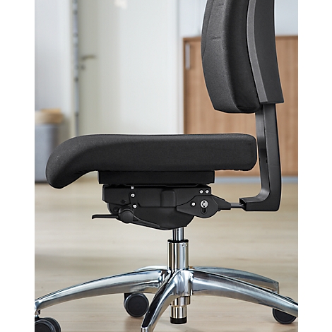 Close-up of a black office chair. Padded seat, chrome frame, casters, ergonomic backrest.
