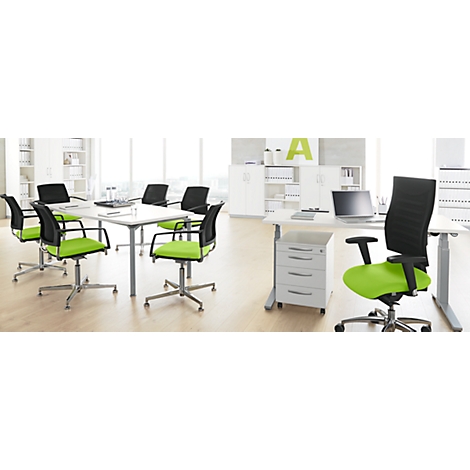 Office with light green office chairs. A table with a laptop and several chairs.