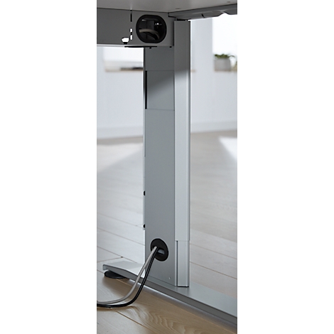 Close-up of a gray, height-adjustable desk leg. Cables run through openings in the leg.