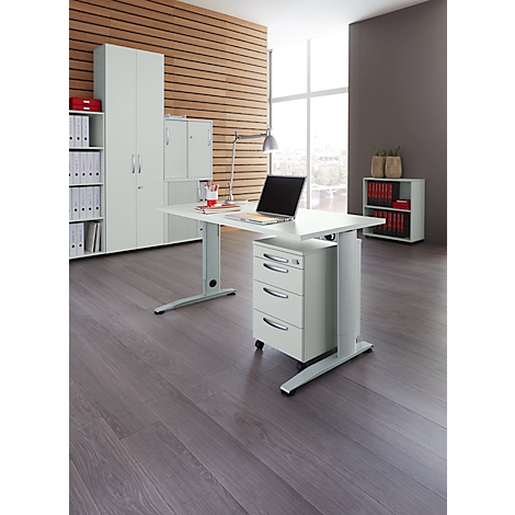 Office with white desk, steel base, drawers, laptop, wood paneling, file cabinets and window.