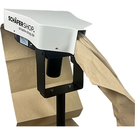 Een apparaat voor papieren zakken. SCHÄFER SHOP staat op het witte gedeelte. Een bruine papieren zak komt uit de opening.