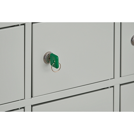 A close-up of a grey locker with a green key in the lock.