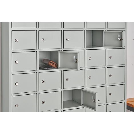 Light grey locker with open compartments. One compartment contains a wallet and a cell phone.