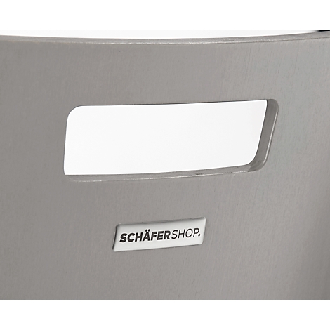Grey chair with a rectangular recess, under which is a sign with "SCHÄFERSHOP".