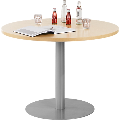 Round wooden table with drinks, magazine, grey leg and stand.