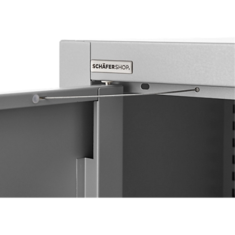 Detail of an opened steel door with wire mechanism. Top: "SCHÄFER SHOP" lettering.