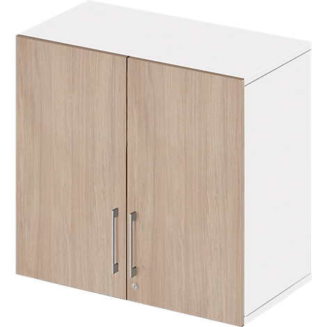 Wall cabinet with two doors made of light wood and white sides. Two metal handles. Simple design.