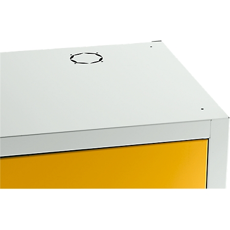 Gelb-weißes Metallgehäuse, leicht von oben fotografiert. Auf der Oberseite befindet sich ein sechseckiger Ausschnitt.