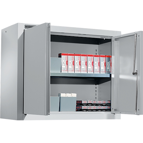 Grey cabinet with open doors filled with packages.