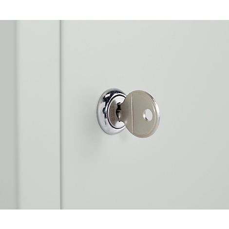 Close-up of a key in a keyhole. The silver key is inserted into the lock.
