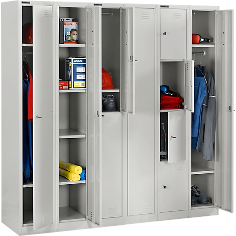 Grey lockers with open doors filled with work clothes, helmets, shoes, hygiene items, and tools.
