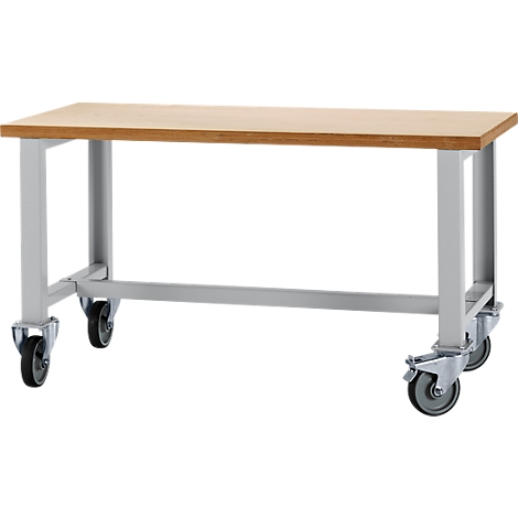 A light-colored table with wheels. Rectangular, light-colored tabletop. Below, a gray frame with castors.