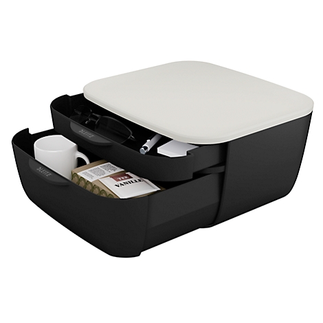 Schwarze Schubladenbox mit cremefarbenem Deckel, gefüllt mit Brille, Stift, Becher und Vanille-Verpackung.