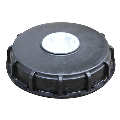 Black plastic lid with white insert in the middle, photographed from above.