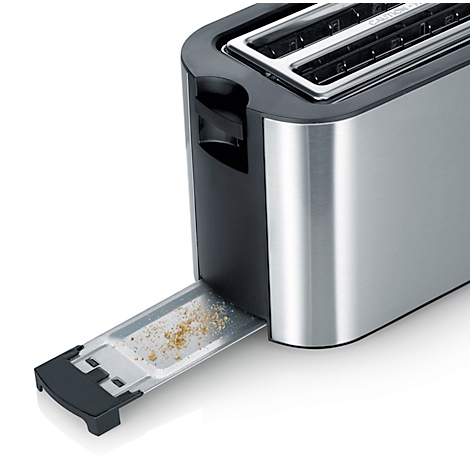 Close-up of a silver toaster with the crumb tray open. Bread crumbs are visible inside.