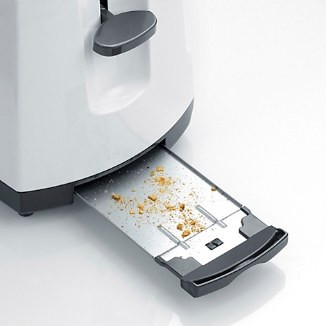 Nahaufnahme eines Toasters mit herausgezogener Krümelschublade, gefüllt mit Brotkrümeln.